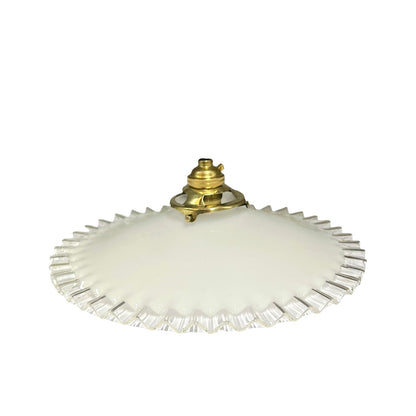 A vintage-style ceiling light fixture with a wide, flared white glass shade featuring a scalloped or fluted edge and a central brass metal mount.
