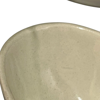 Beige ceramic dish with floral design and 'L'avocat' text on a white background