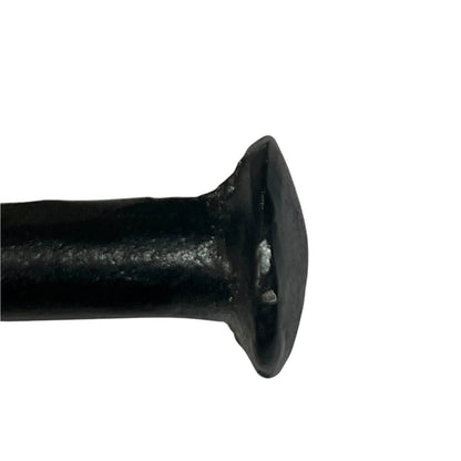 A close-up of a black toilet paper holder