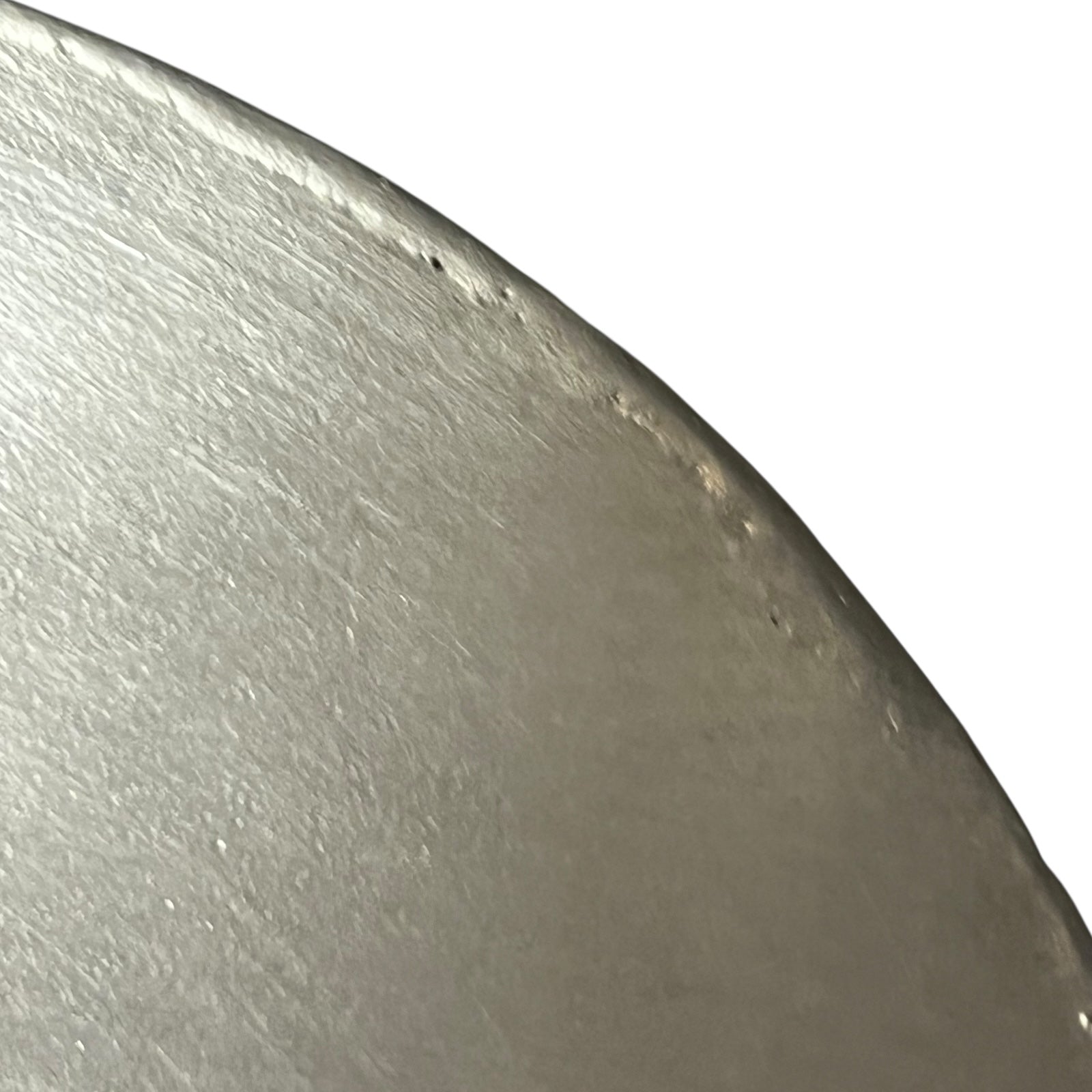 Close-up of a copper pan lid with brand new tin lining on a white background