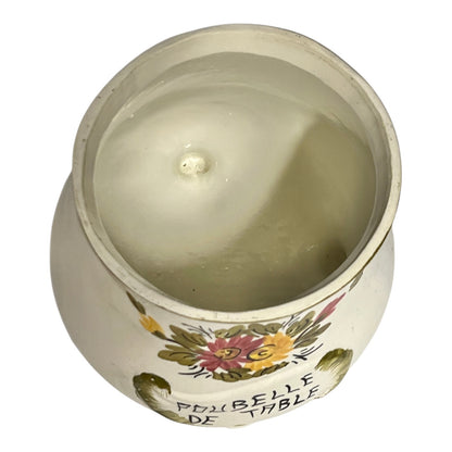 Decorative candle in a pot with floral designs and text on a white background
