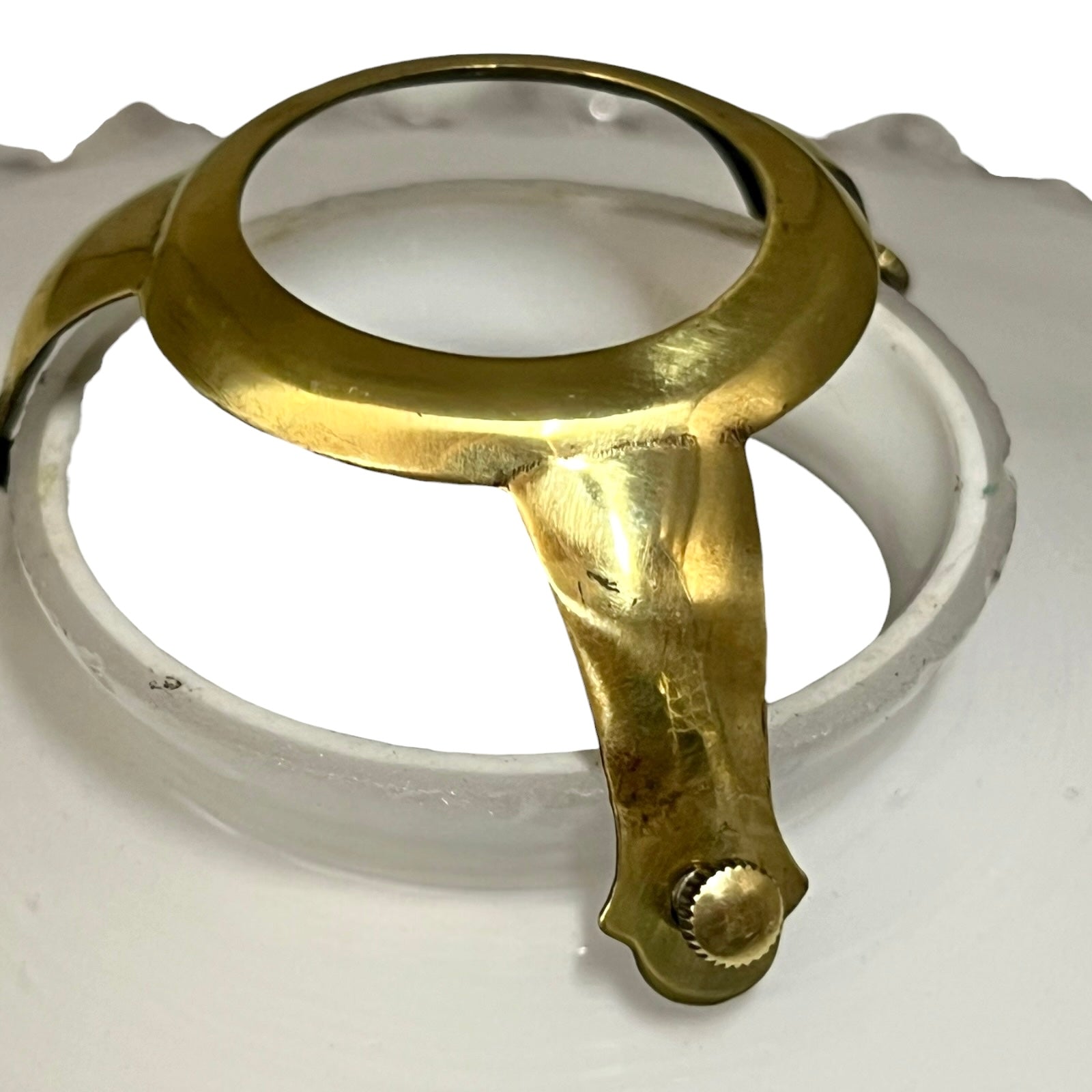 Brass magnifying glass on a white background