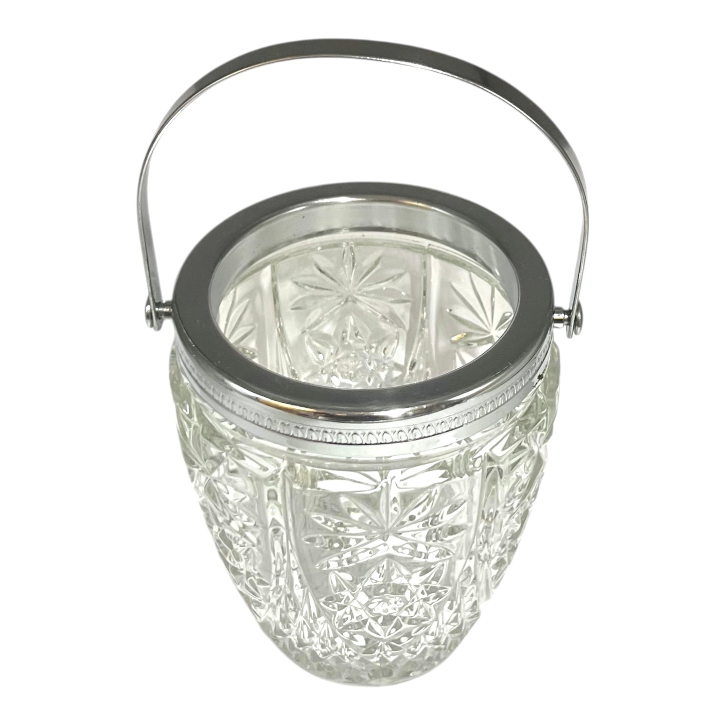 Decorative glass vintage ice bucket with metal collar and handle on a white background