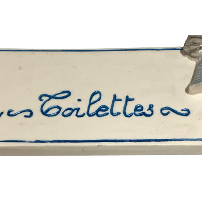 Decorative novelty door sign for a toilet labelled in French as Toilettes, with a goose reading a newspaper  decoration on a white background