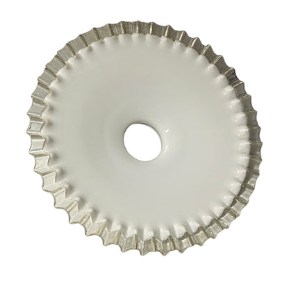 Close-up of a milk-glass frilled-edge lampshade against a white background.