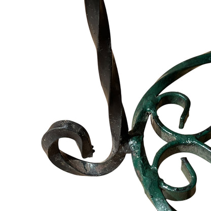 Close up of a wrought iron vintage plant stand on a white background 