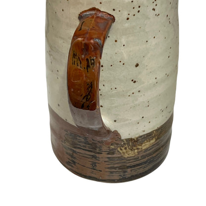 close up of ceramic glazed pitcher jug on a white background 
