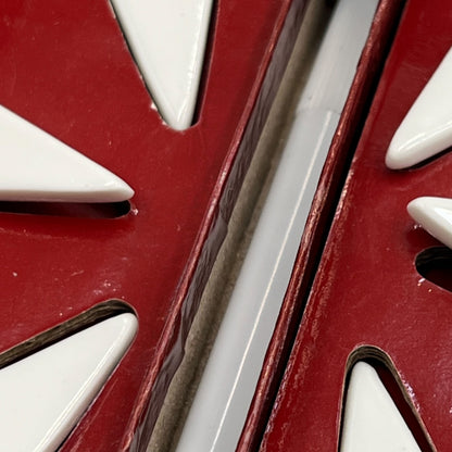 Close up of a porcelain cheese label in a red box on a white background