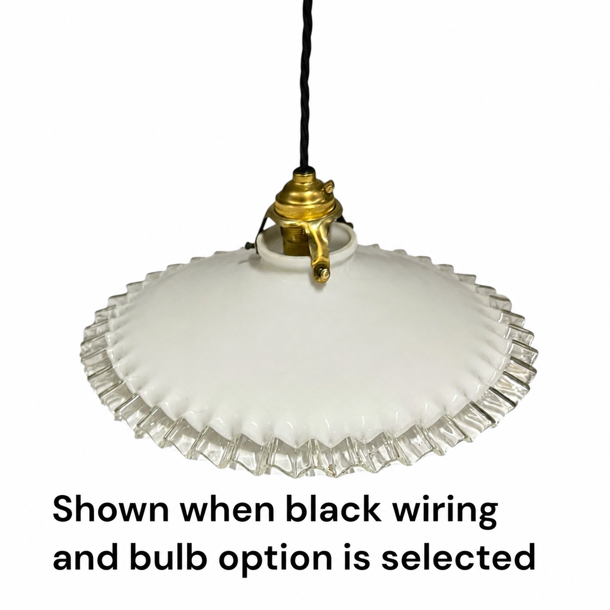A vintage-style white glass pendant light with a scalloped edge and a gold-toned metal fixture, suspended by a black cord against a white background. Text at the bottom reads, 'Shown when black wiring and bulb option is selected.