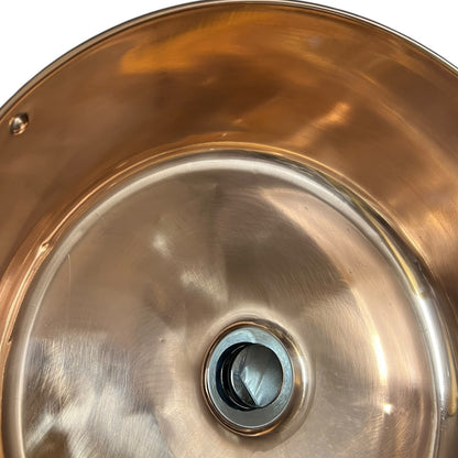 Close up of a copper sink on a white background 