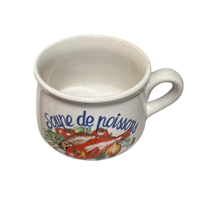 White mug with colorful fish design and text on a white background