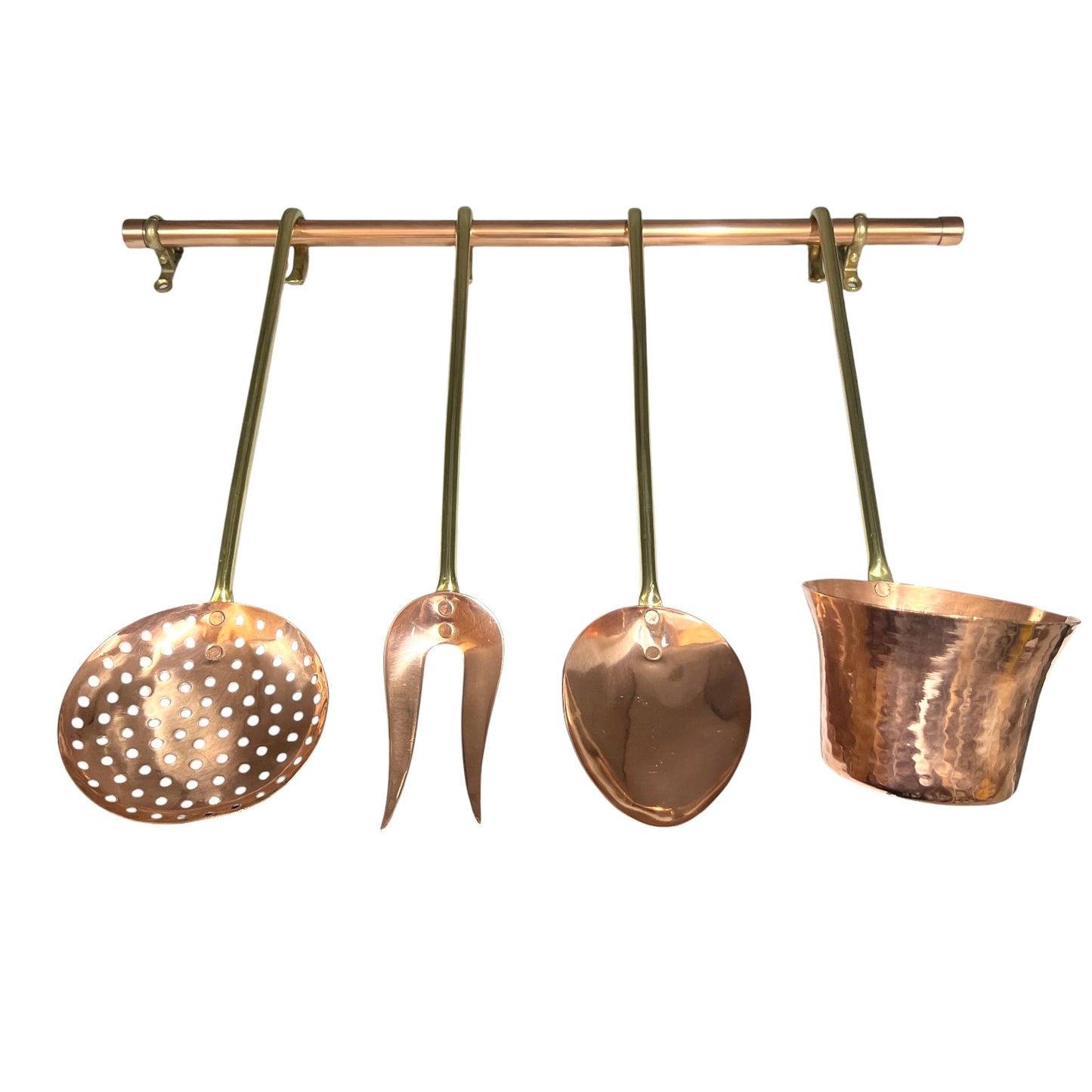 A set of four hammered copper kitchen utensils hanging from a copper rod against a plain white background. The utensils include a perforated skimmer, a two-pronged turner, a large spoon, and a small ladle or scoop.