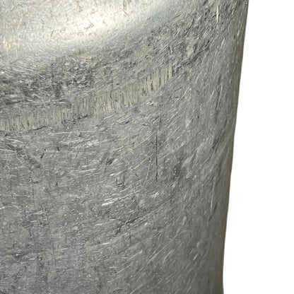 close up of metal milk churn on a white background