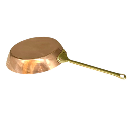 French Copper frying pan with a brass handle on a white background