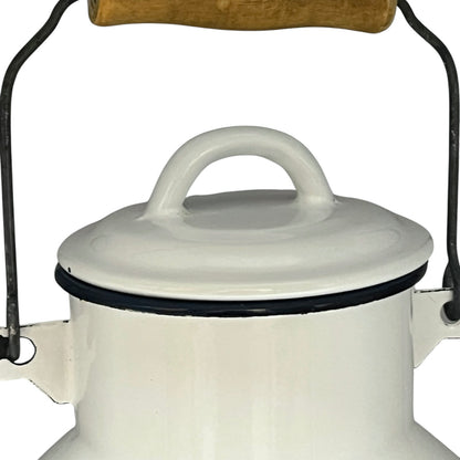 Close up of a white enamel milk churn and mug with duck design on a white background