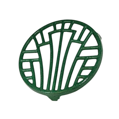Green vintage French cast iron enamelled pan trivet on a white background