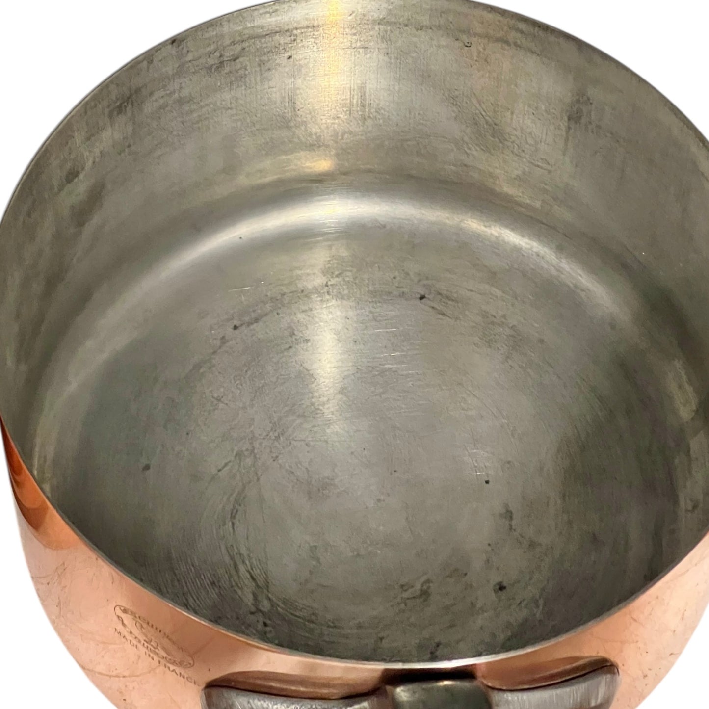 Close-up of copper cookware with iron handles on a white background
