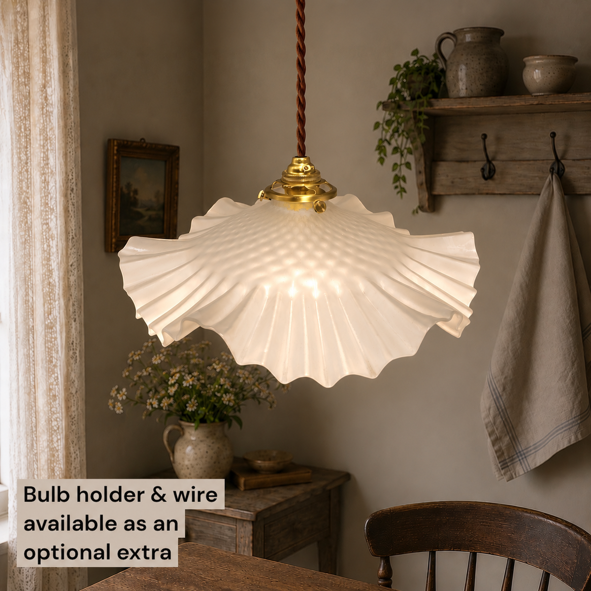French vintage frosted glass lampshade with a brown twisted wire set in a rustic kitchen 