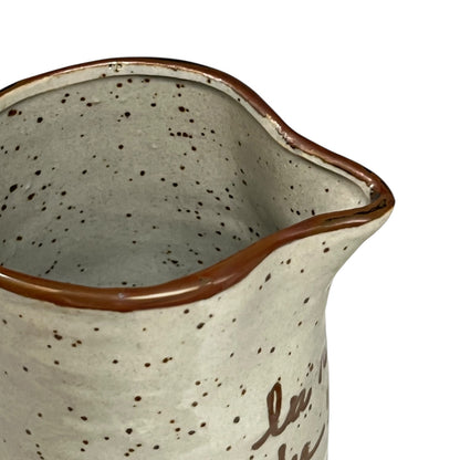 close up of ceramic glazed pitcher jug on a white background 