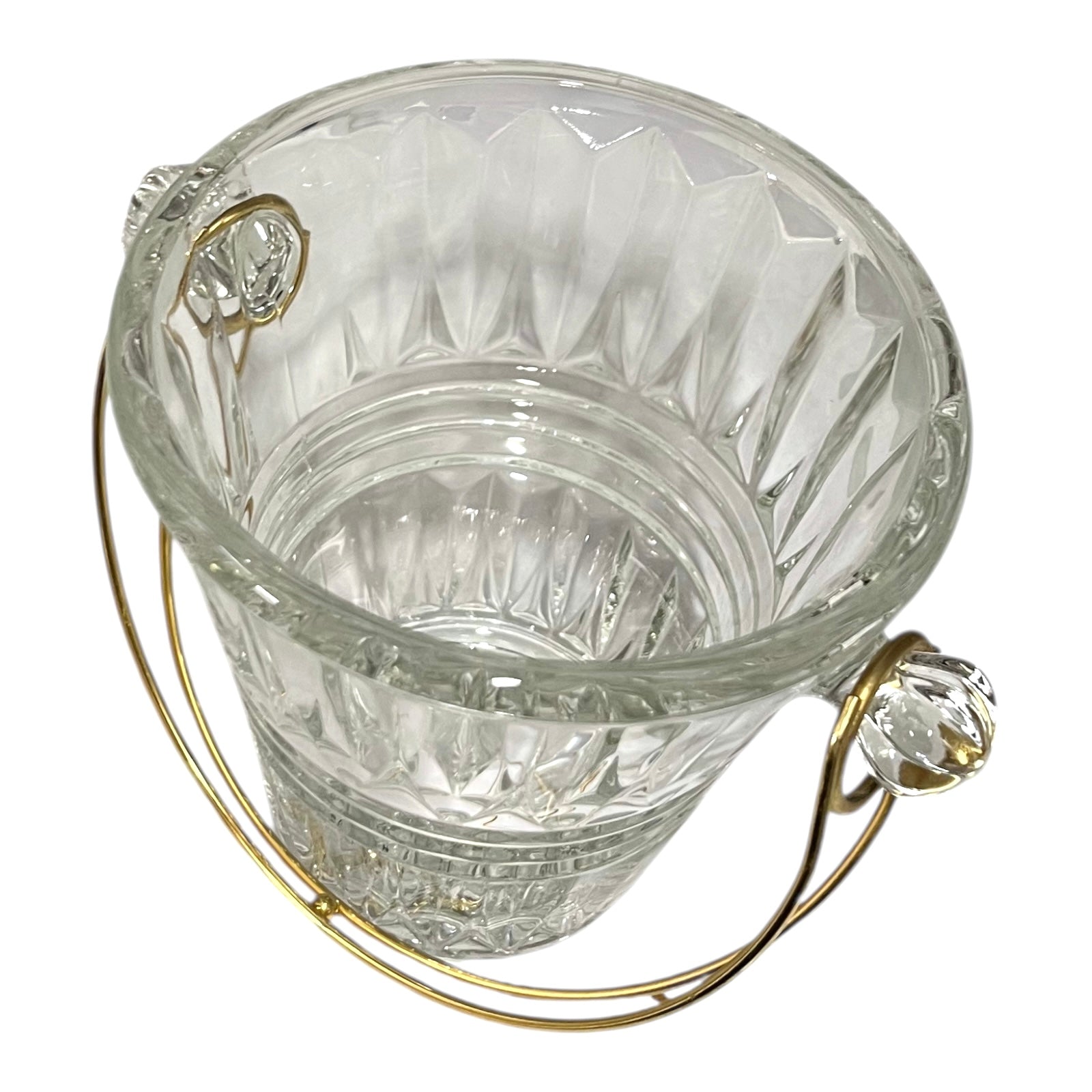 Clear glass ice bucket with decorative handles on a white background