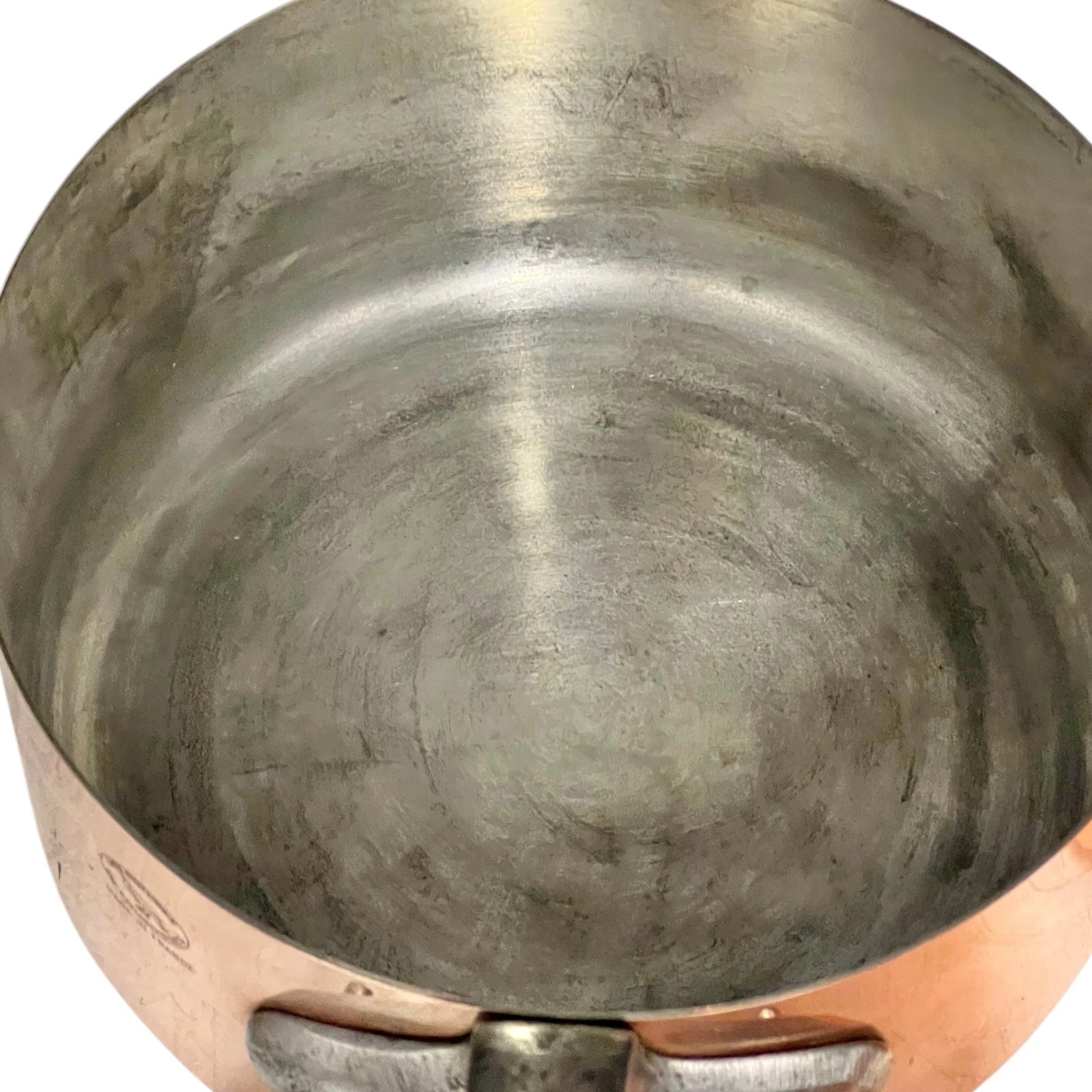 Close-up of copper cookware with iron handles on a white background