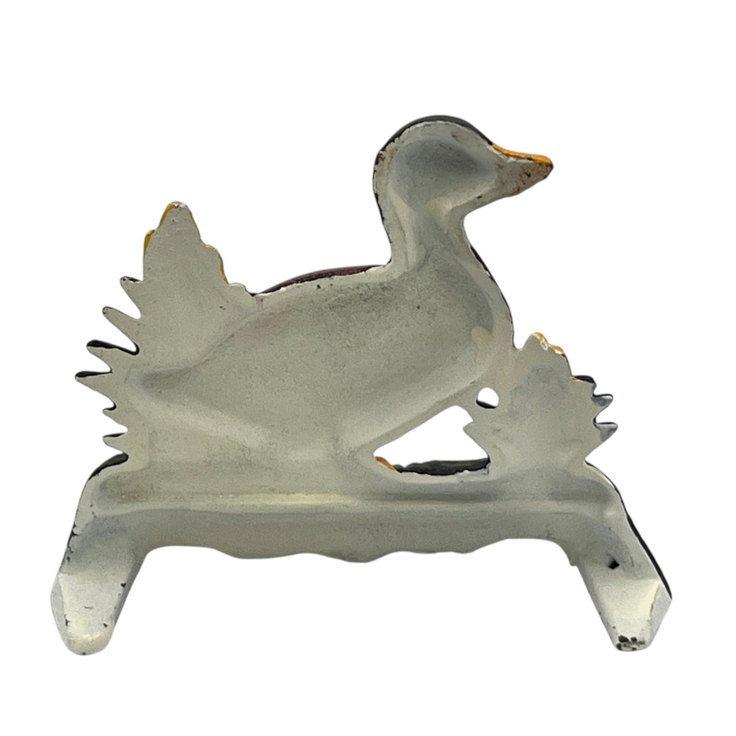 Close up of duck doorstop on a decorative stand with a white background
