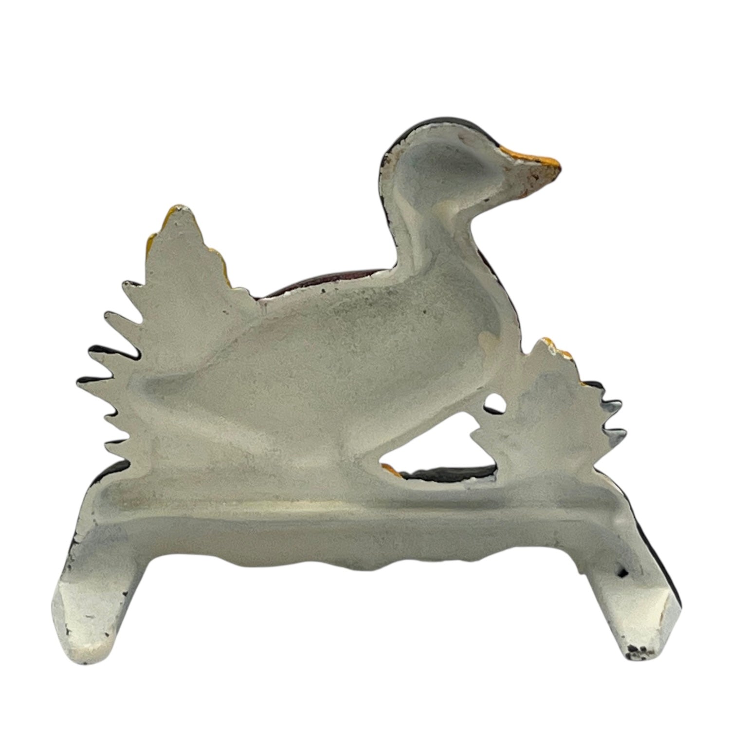 Close up of duck doorstop on a decorative stand with a white background
