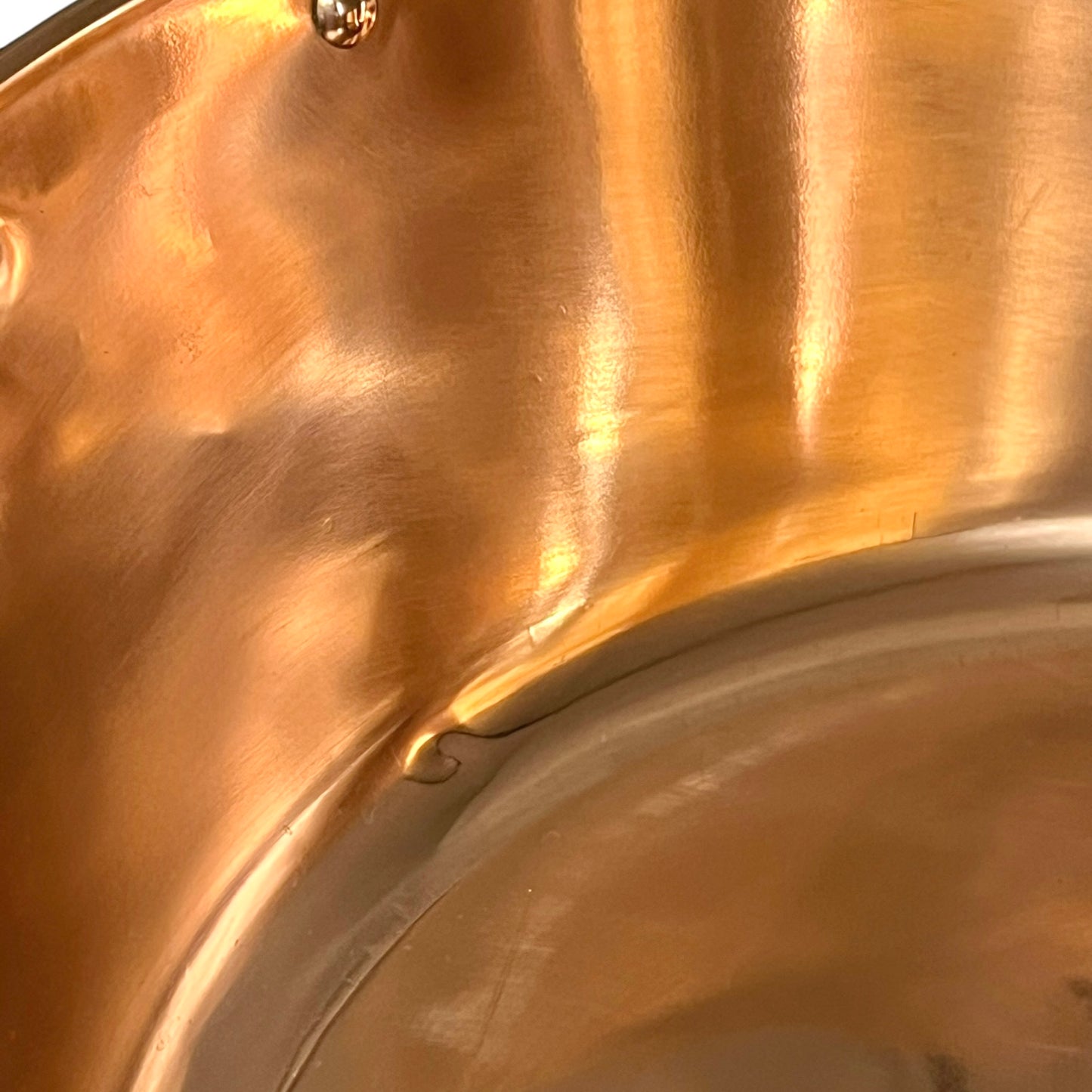 Close up of a copper sink on a white background 