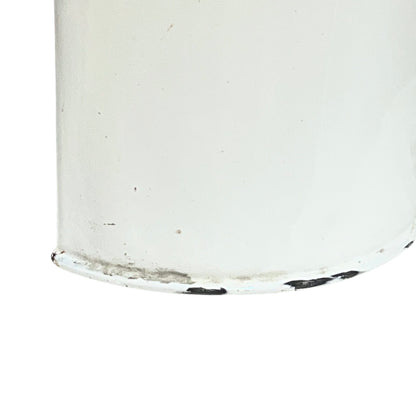 Close up of  French vintage enamel planter with a flat back and a spout on a white background