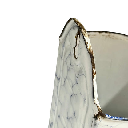 Close up of a vintage French enamel irrigator hanging hole