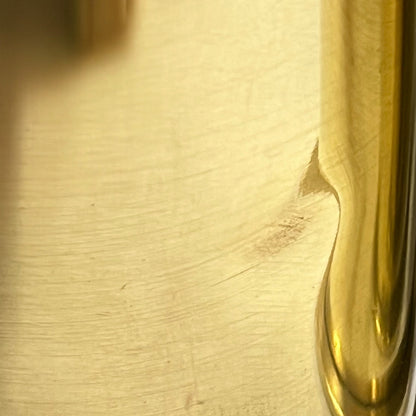 Close up of a brass WW1 German shell case on a white background
