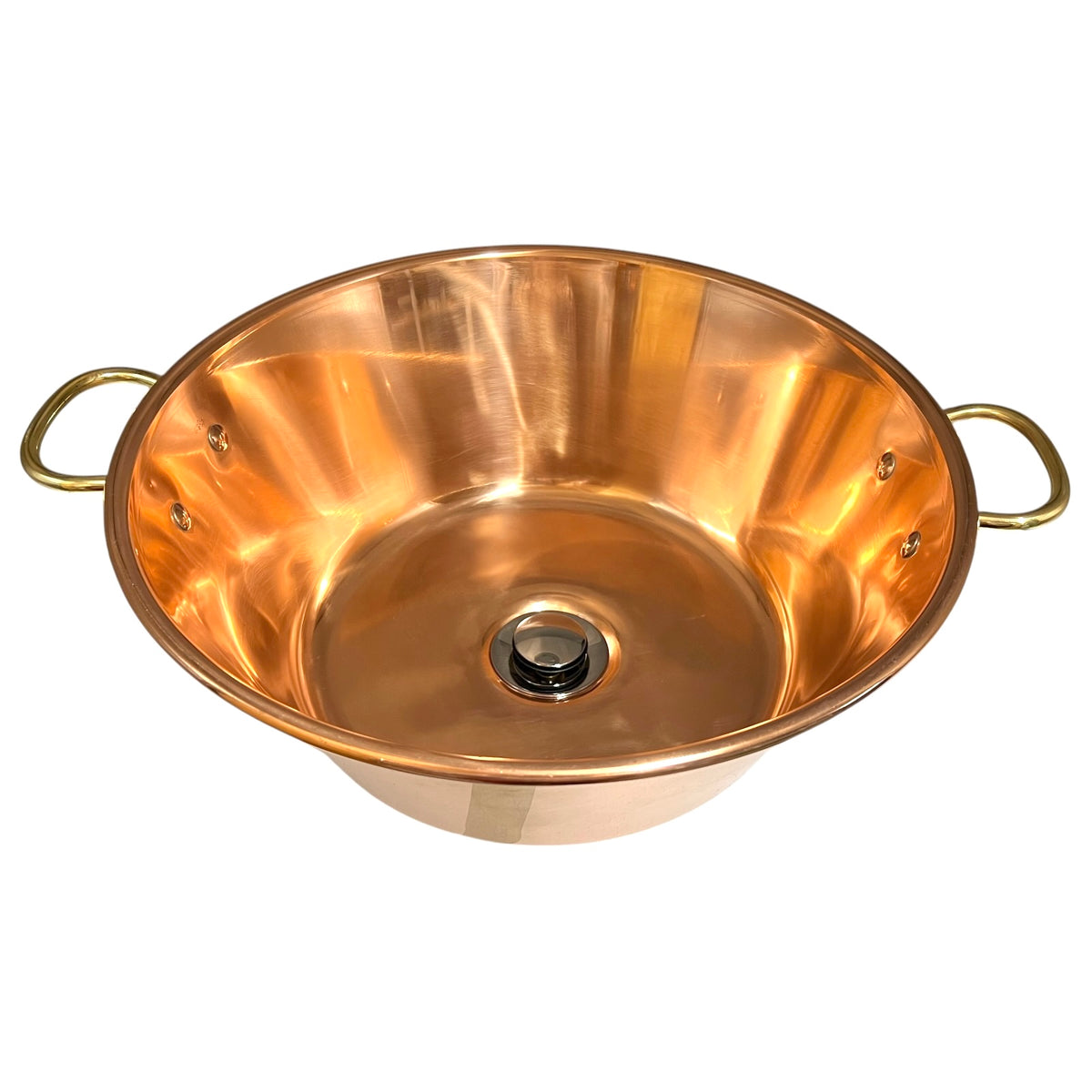 A copper sink bowl with two loop handles on the sides and a central drain opening, photographed on a plain white background.