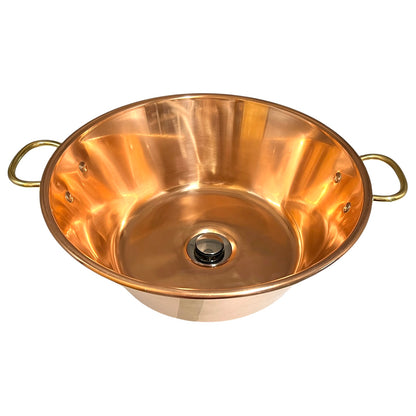 A copper sink bowl with two loop handles on the sides and a central drain opening, photographed on a plain white background.