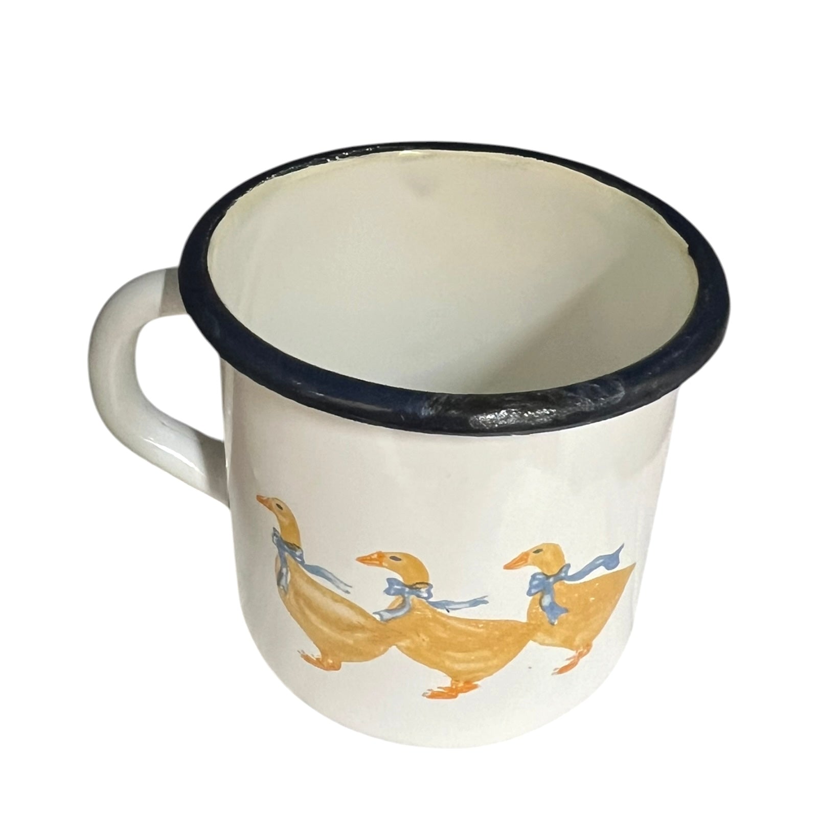 Close up of a white enamel milk churn and mug with duck design on a white background