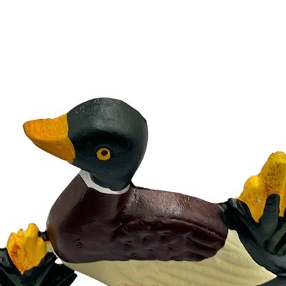 Close up of duck doorstop on a decorative stand with a white background