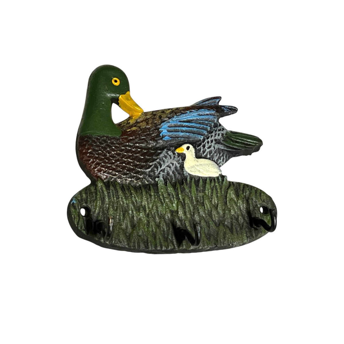 A decorative duck figurine featuring a large green-and-brown mallard with blue wing feathers and a small white duckling, mounted on a grass-textured base against a plain white background.