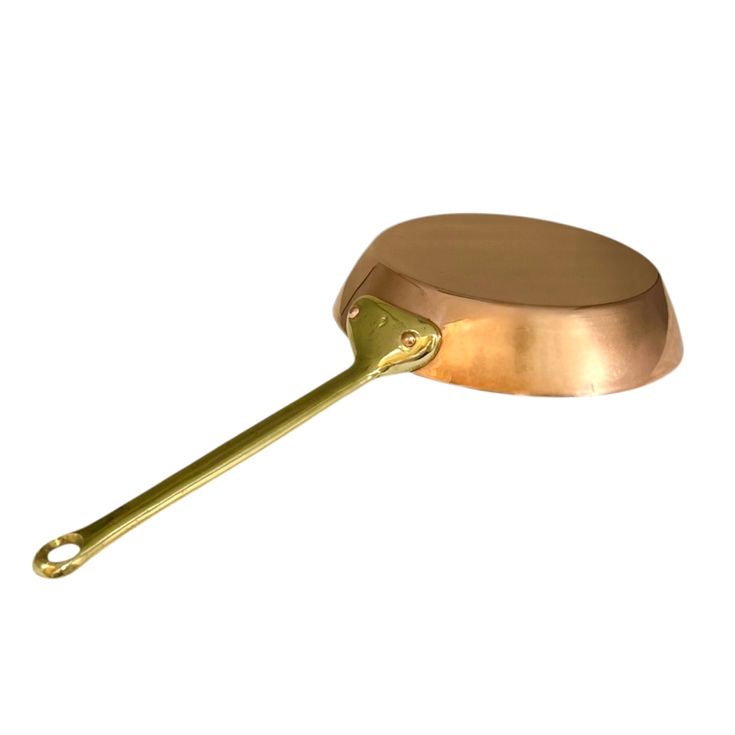 Copper frying pan with a brass handle on a white background
