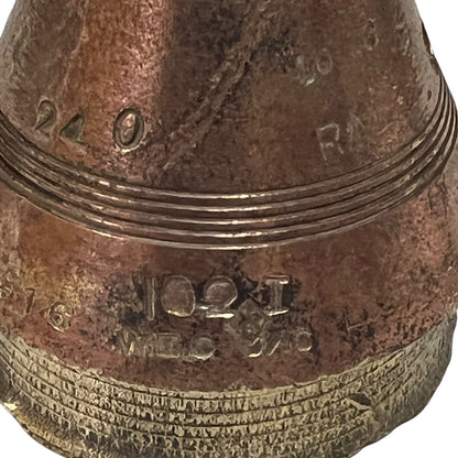 Close up of WW1 relic brass fuse on a white background