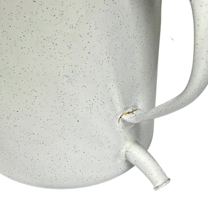 Close-up of a enamel planter with speckled pattern on a white background