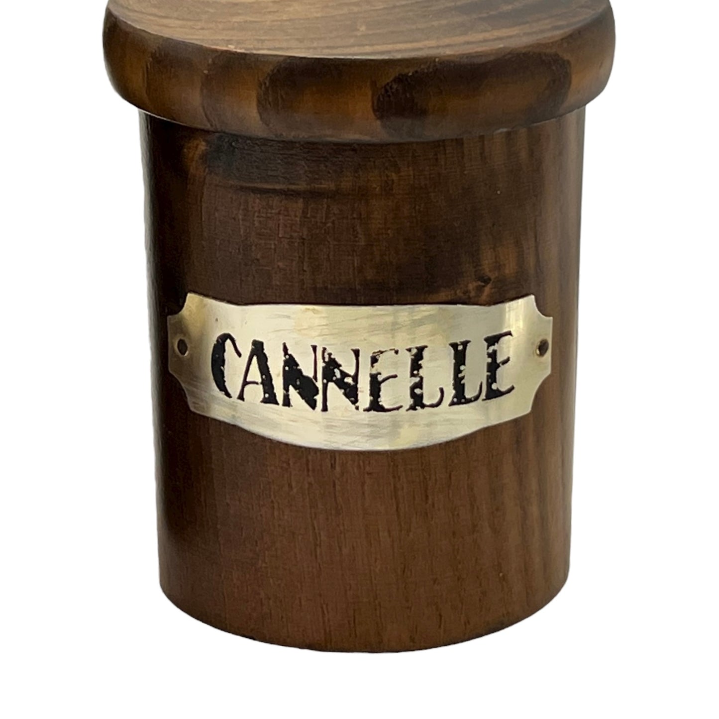 Wooden container with a brass label reading 'Cannelle' on a white background