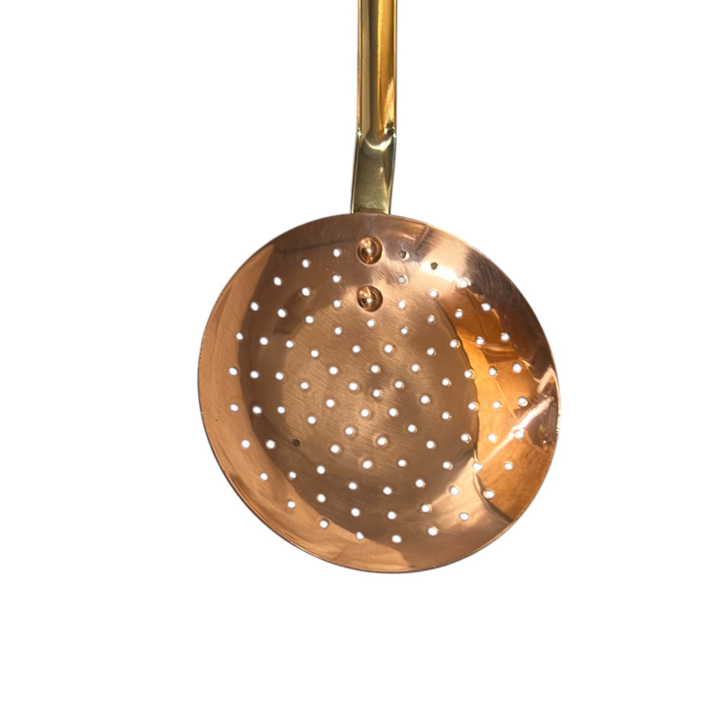 Copper skimmer with a gold handle on a white background
