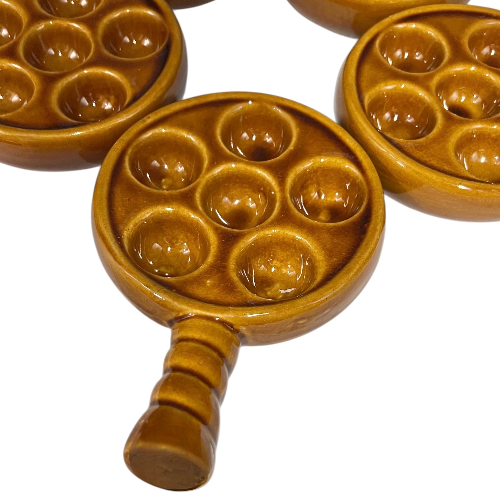set of 5 amber brown coloured 6 hole snail plates on a white background 