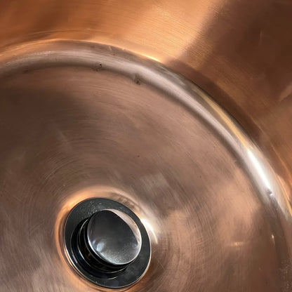 Close-up of a copper sink on a white background