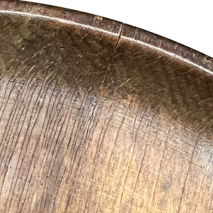 close up of a wooden decorative round plaque on a white background 