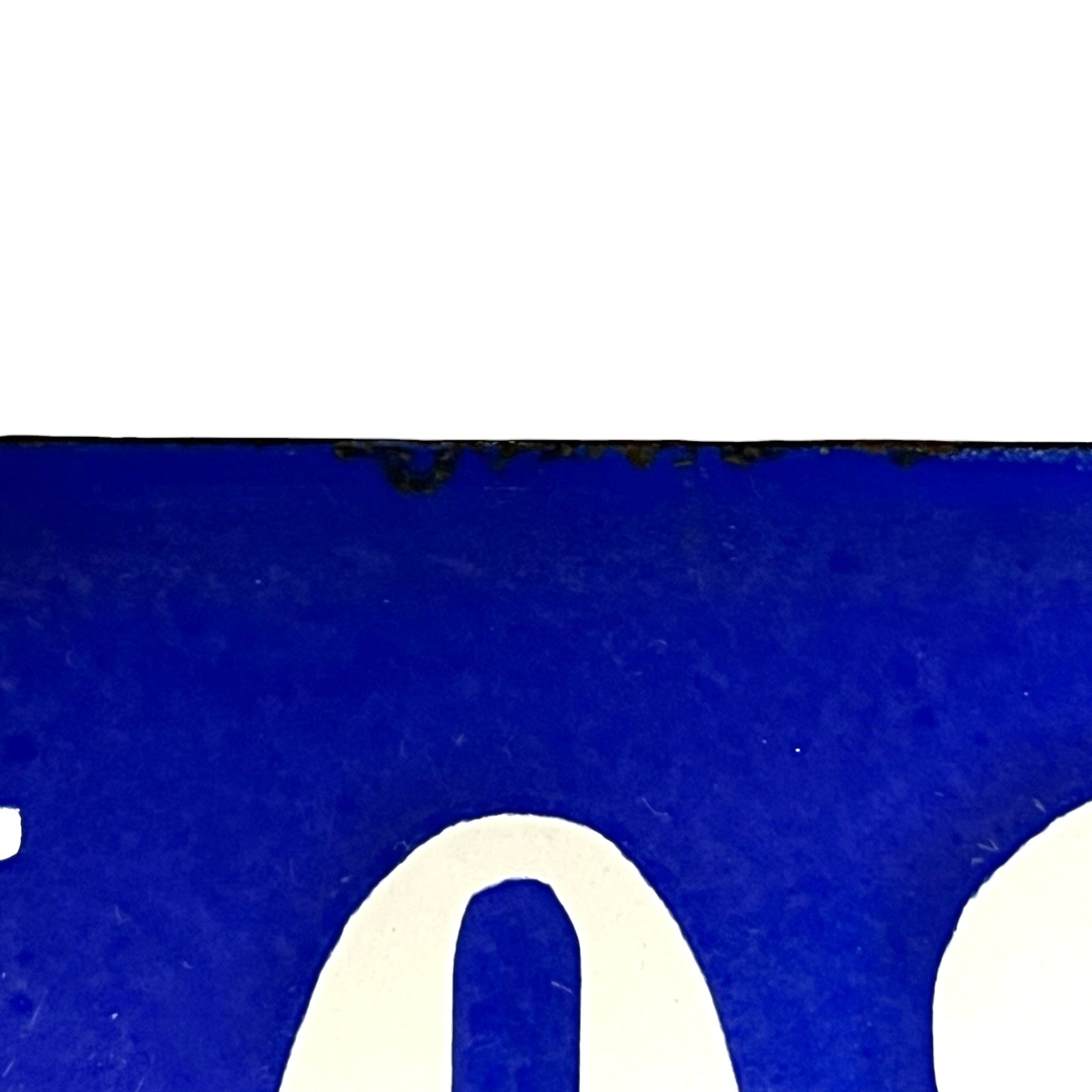 Close-up of a blue  plate with white text on a white background