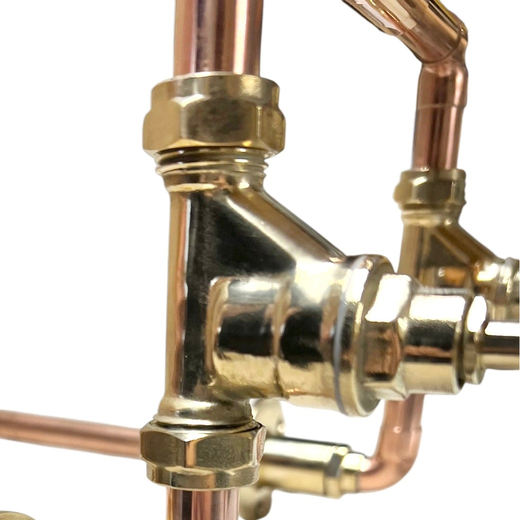 Close-up of brass and copper plumbing components on a white background