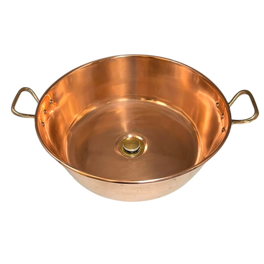 Copper up cycled basin sink with brass handles and a brass pop up waste drain on a white background 