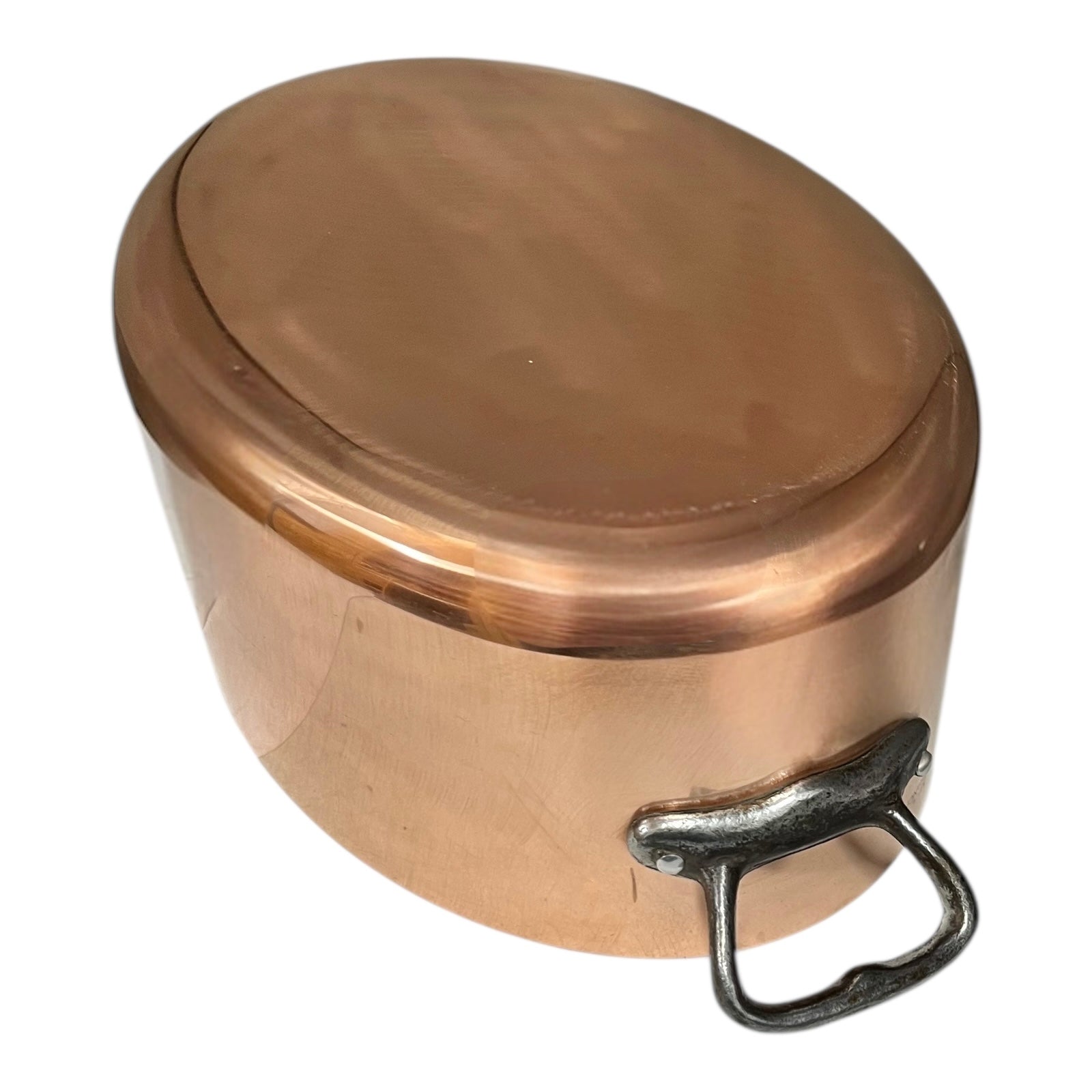 Close-up of a  copper pot handle on a white background