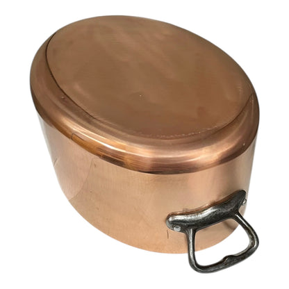 Close-up of a  copper pot handle on a white background