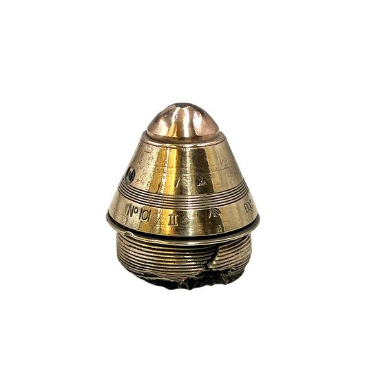 Polished British brass WW1 fuse or paperweight type 101 on a white background